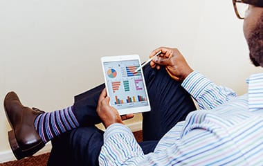 A man is sitting and drafting a project on IPad